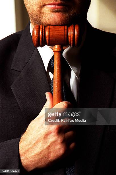 Wooden hammer held by a businessman