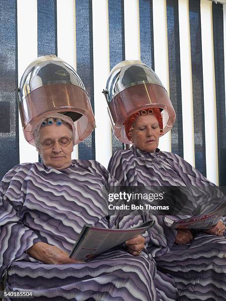 women drying hair at hair salon - vintage beauty salon stock-fotos und bilder