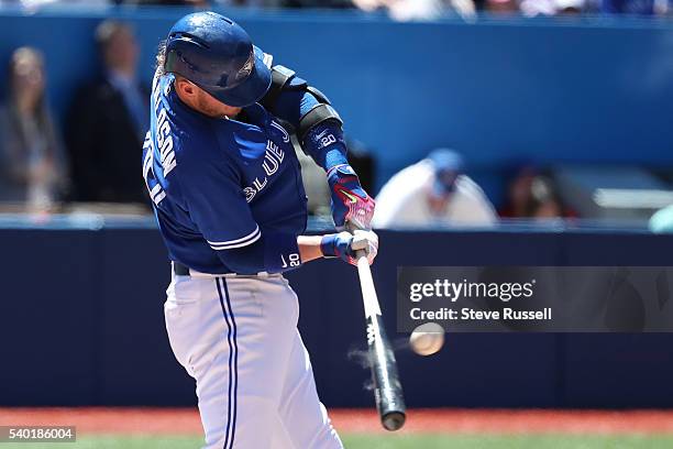 Josh Donaldson hits a long fly ball as the Toronto Blue Jays play an afternoon game against the Philadelphia Phillies in Toronto. June 14, 2016.