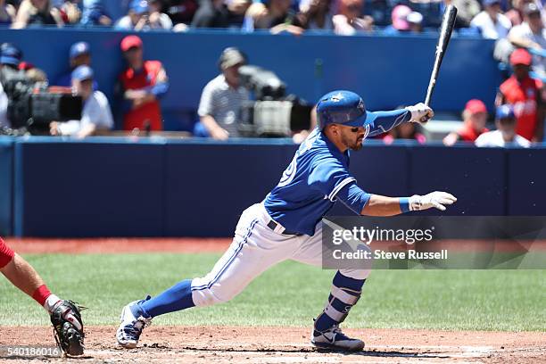 Russell Martin hits a single as the Toronto Blue Jays play an afternoon game against the Philadelphia Phillies in Toronto. June 14, 2016.