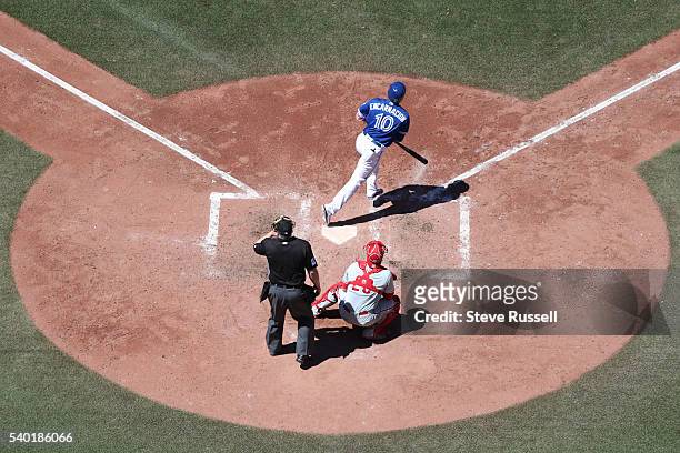 Edwin Encarnacion homers in the seventh inning as the Toronto Blue Jays play an afternoon game against the Philadelphia Phillies in Toronto. June 14,...