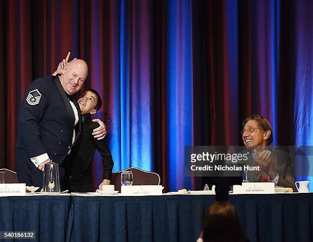 Event honoree Christopher A. Irving hug his son during the 75th Annual Father Of The Year Awards Luncheon at New York Marriott Marquis Hotel on June...