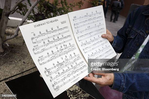 Led Zeppelin fan holds up sheet music for "Stairway to Heaven" outside of federal court in Los Angeles, California, U.S., on Tuesday, June 14, 2016....