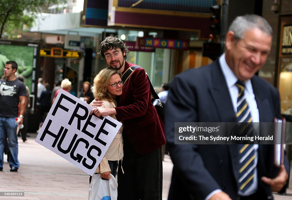 Juan Mann dispenses 'free hugs' to passers-by in Sydney's Pitt Street Mall, afte