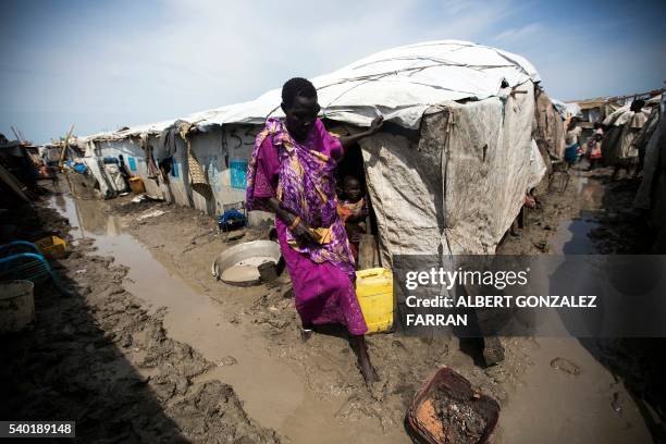 Woman walks outside her shelter in the Protection of Civilians site in Malakal, on June 14, 2016. The rainy season started and made the living...