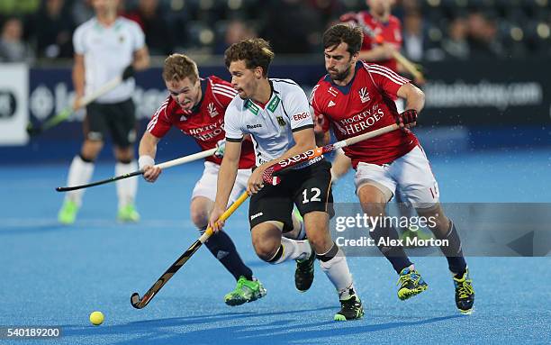 Ian Sloan of Great Britain, Timm Herzbruch of Germany and Adam Dixon of Great Britain during the FIH Mens Hero Hockey Champions Trophy match between...