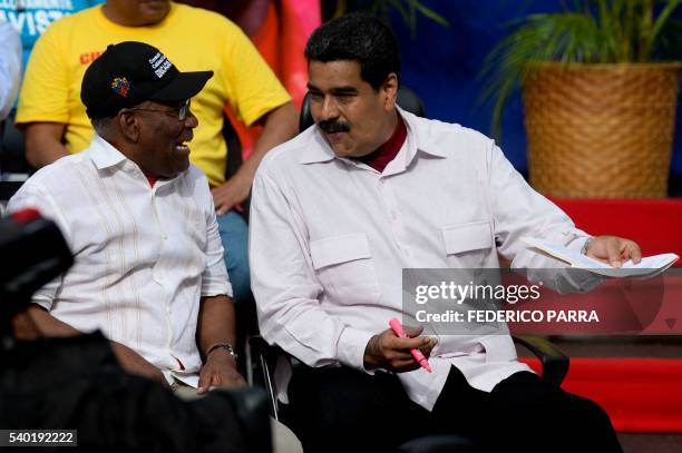 Venezuelan President Nicolas Maduro talks with Vice President Aristobulo Isturiz during a rally in Caracas on June 14, 2016. - The US and Venezuelan...