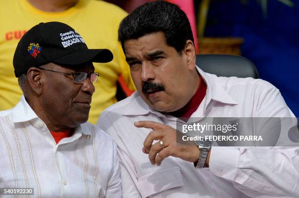 Venezuelan President Nicolas Maduro talks with Vice President Aristobulo Isturiz during a rally in Caracas on June 14, 2016. - The US and Venezuelan...