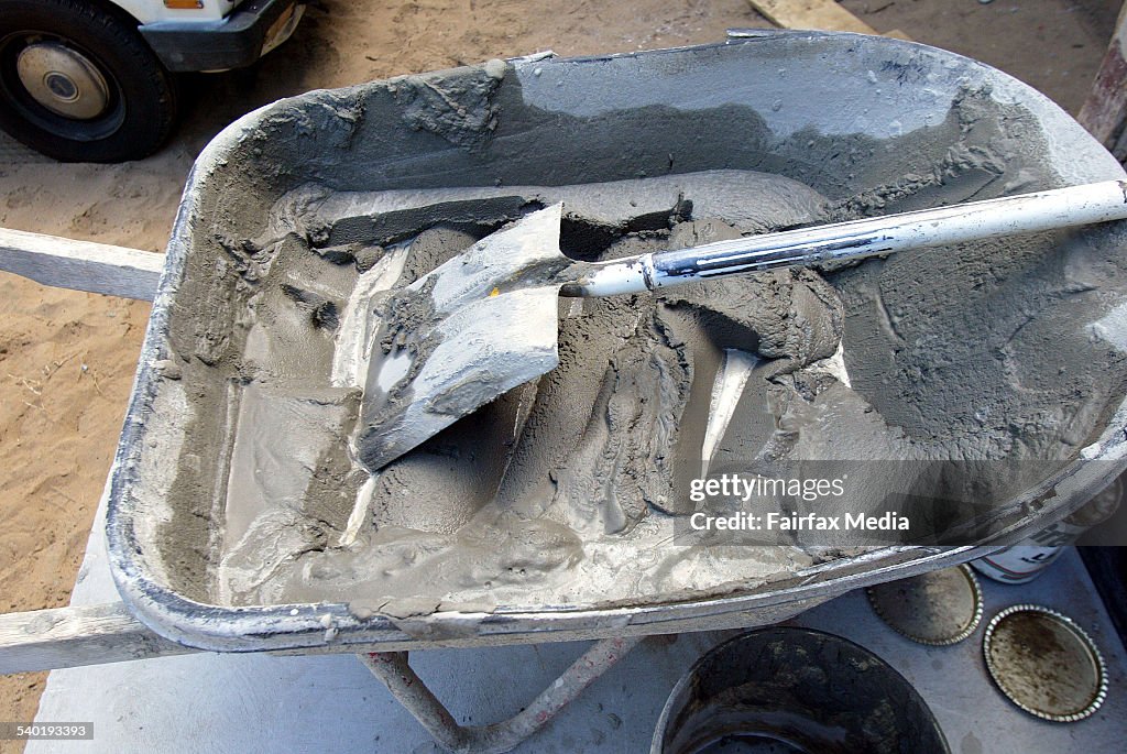 Cement in a wheel barrow mixed for a brick layer