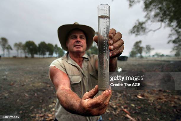 Angus Cattle farmer Rod Manning from Mansfield who is happy to have received 23mm of rain today. 20 March, 2007. THE AGE NEWS Picture by WAYNE TAYLOR.