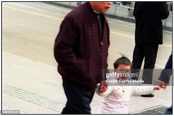 Couple walk with their grandchild in Shanghai