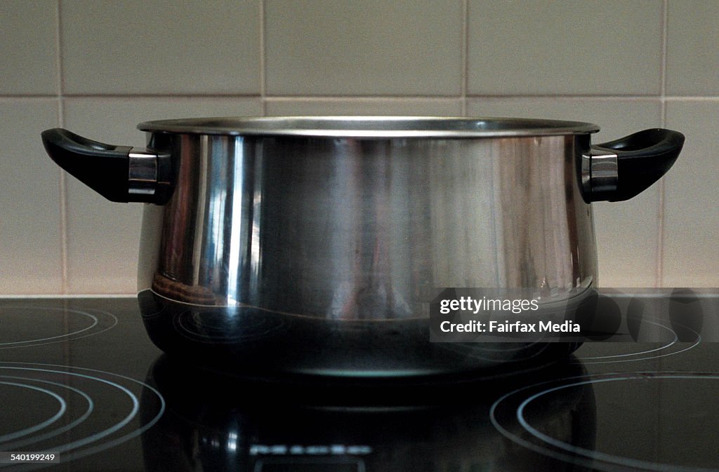 Stainless steel saucepan on a ceramic cooktop in a kitchen