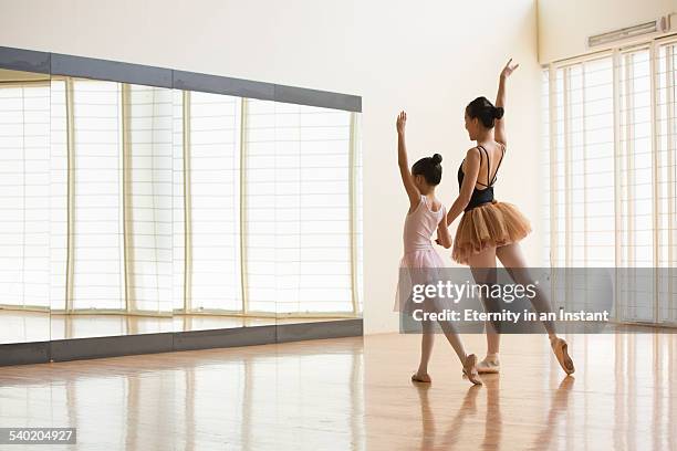 ballet teacher teaching a young ballerina - dance teacher foto e immagini stock