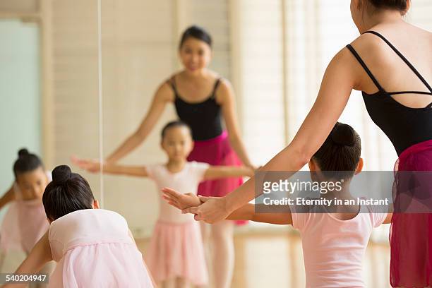 ballet teacher teaching young students - singapore school stock-fotos und bilder