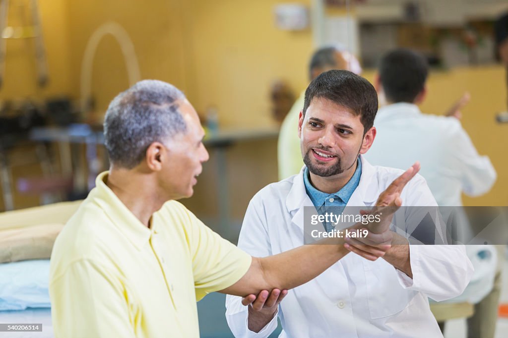 Hispanic physical therapist, African American patient