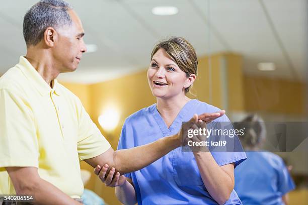 female physical therapist, african american patient - orthopedic surgeon stock pictures, royalty-free photos & images