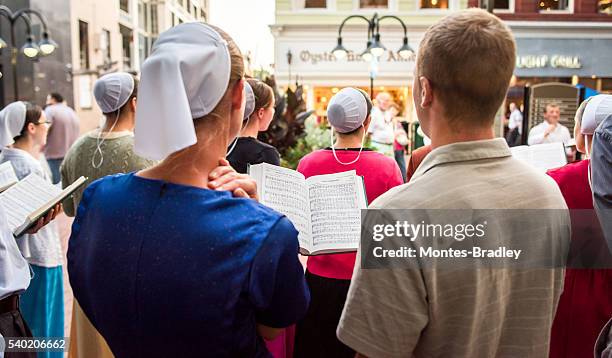 mennonite choir in downtown mall - amish stock pictures, royalty-free photos & images