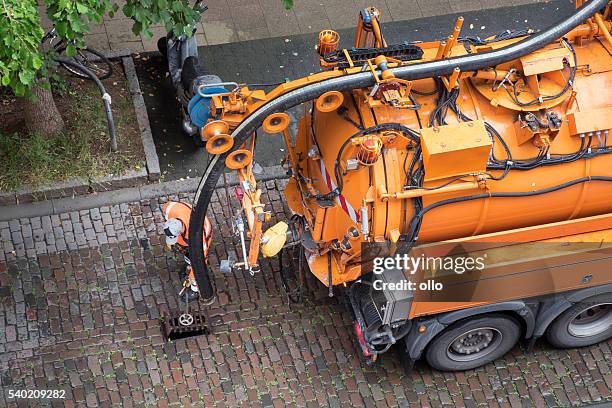 worker and sewage truck, high-angle view - road cleaner stock pictures, royalty-free photos & images