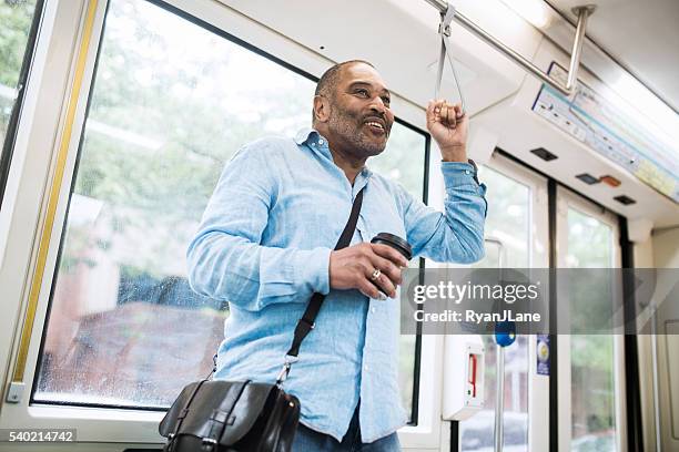 ältere pendler sie mit öffentlichen verkehrsmitteln - lightrail stock-fotos und bilder