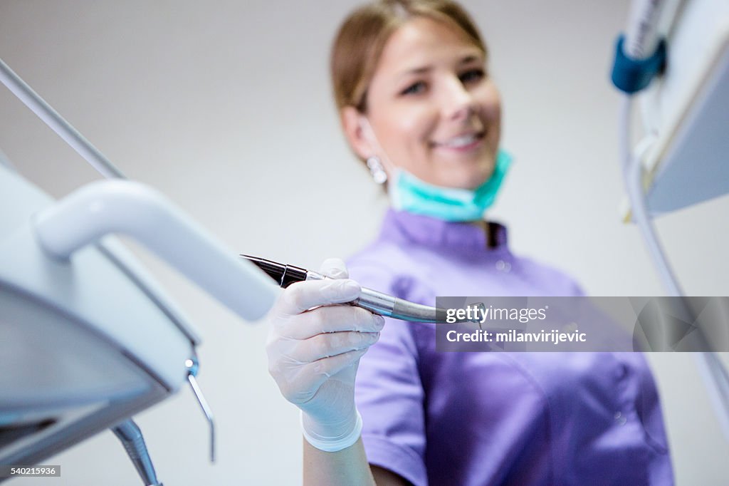 Young female dentist at her office