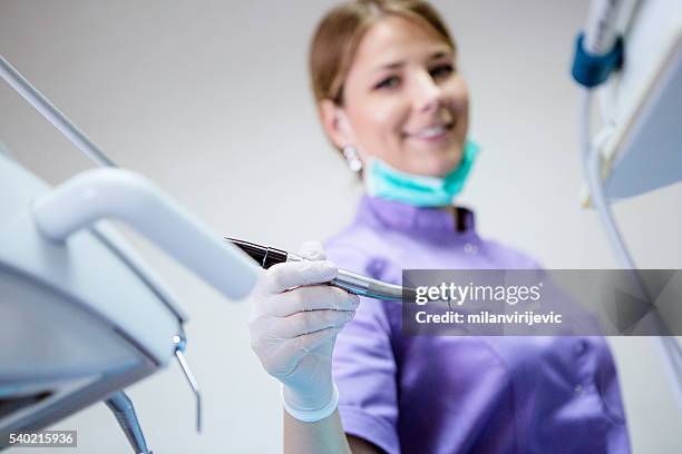 young female dentist at her office - dental drill stock pictures, royalty-free photos & images