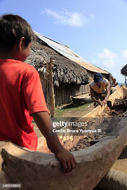 locals making a dugout canoe - family red canoe stock pictures, royalty-free photos & images