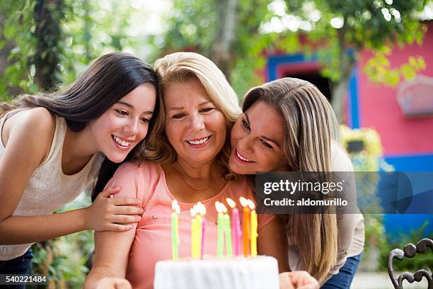 abuela celebrando su cumpleaños - mujeres de mediana edad fotografías e imágenes de stock