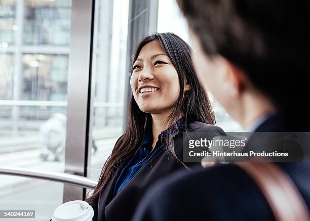 asian businesswoman in elevator - business meeting chinese stock pictures, royalty-free photos & images