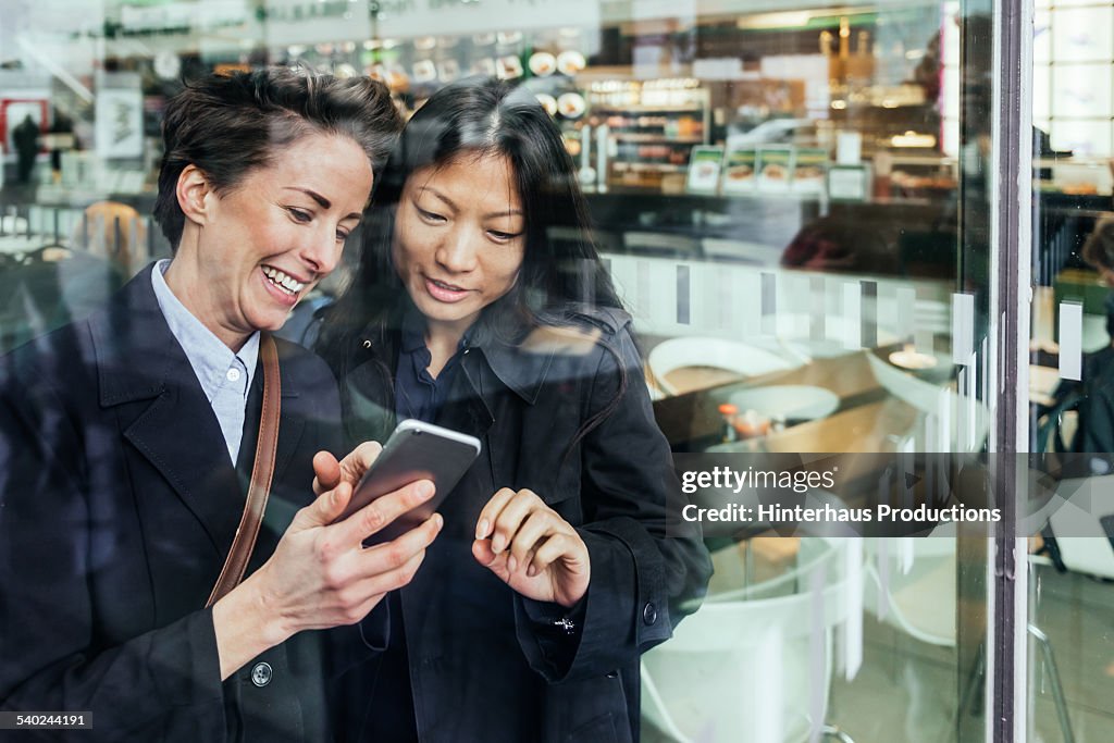 Two Businesswomen With Smart Phone