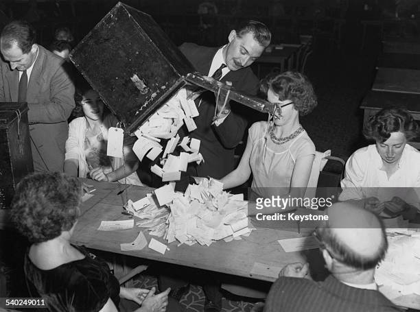Ballot boxes are emptied ready for counting at St. Pancras Town Hall for the General Election, London, 9th October 1959.