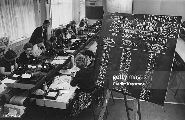 Staff at London bookmakers Ladbrokes busy taking bets for the upcoming General Election, 6th October 1964.