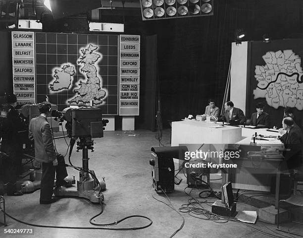 English journalist and broadcaster Richard Dimbleby prepares with statisticians during rehearsals for the B.B.C.'s General Election live coverage at...