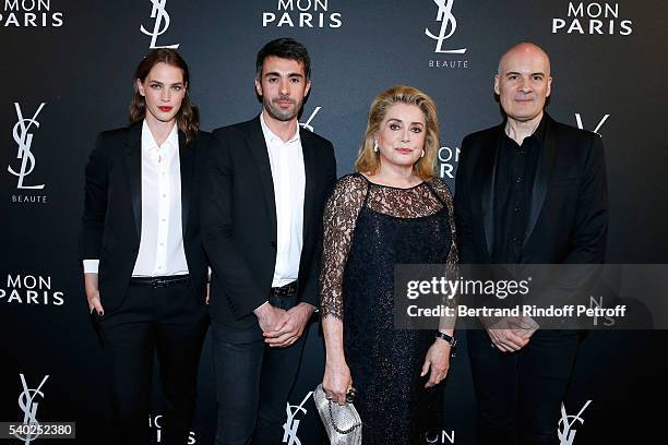 Egeria of YSL Beauty, model Crista Cober, guest, actress Catherine Deneuve and General Director of of Yves Saint Laurent, Stephan Bezy attend YSL...