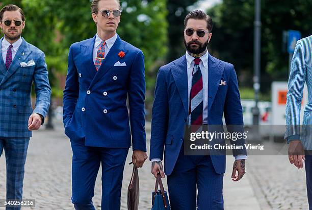 Guests wearing blue suits during Pitti Uomo 90 on June 14 in Florence, Italy