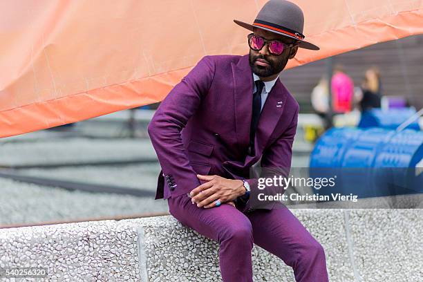 Guest wearing a purple hat during Pitti Uomo 90 on June 14 in Florence, Italy