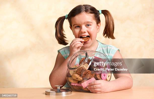 girl enjoying jar of cookies - råttsvans bildbanksfoton och bilder