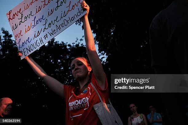 Attendees listen to speakers at a memorial gathering for those killed in Orlando at Grand Army Plaza on June 14, 2016 in the Brooklyn borough of New...