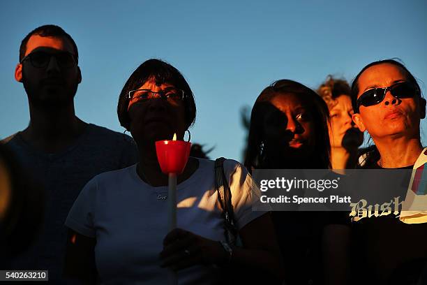 Attendees listen to speakers at a memorial gathering for those killed in Orlando at Grand Army Plaza on June 14, 2016 in the Brooklyn borough of New...