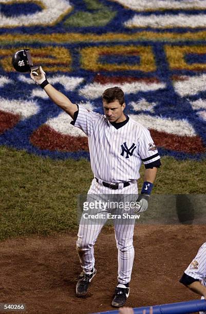 Tino Martinez of the New York Yankees takes a curtain call after hitting a two run home run in the 9th inning to tie the Arizona Diamondbacks during...
