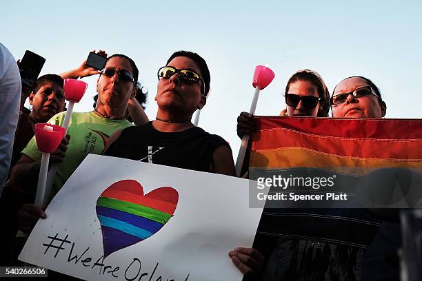 Attendees listen to speakers at a memorial gathering for those killed in Orlando at Grand Army Plaza on June 14, 2016 in the Brooklyn borough of New...