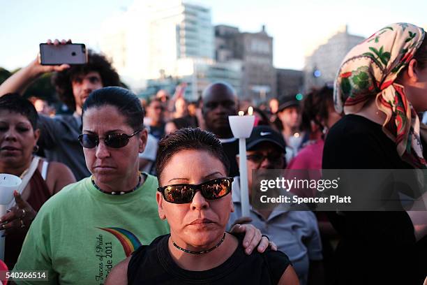 Attendees listen to speakers at a memorial gathering for those killed in Orlando at Grand Army Plaza on June 14, 2016 in the Brooklyn borough of New...