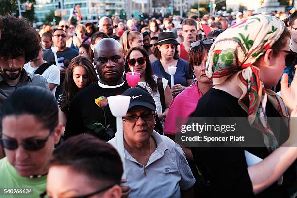 Attendees listen to speakers at a memorial gathering for those killed in Orlando at Grand Army Plaza on June 14, 2016 in the Brooklyn borough of New...