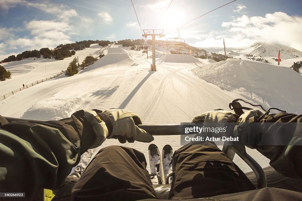 Man sitting on ski lift in the Pyrenees from pov.