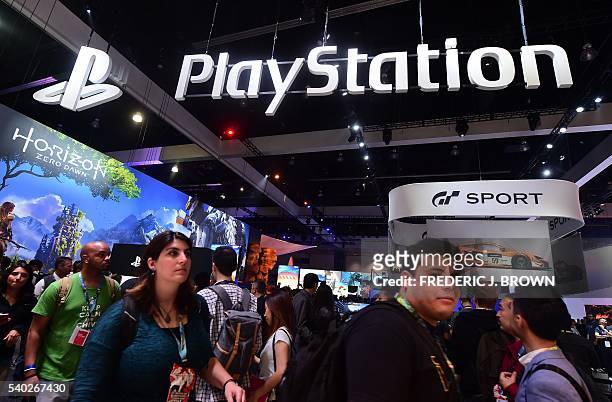 People make their way past the Playstation section during the 2016 Electronic Entertainment Expo annual video game conference and show on June 14,...
