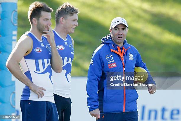 Brad Scott, Senior Coach of the Kangaroos and Jack Ziebell share a joke during a North Melbourne Kangaroos AFL training session at Arden Street...