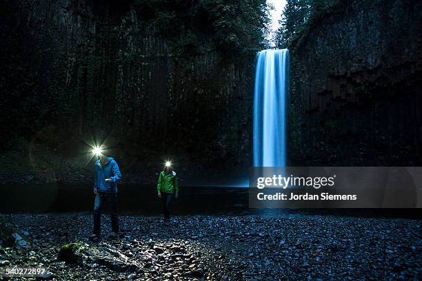 A couple hiking near a waterfall.