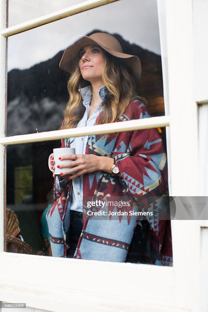 A woman in a hat and wool jacket.