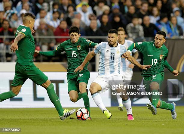 Argentina's Sergio Aguero is marked by Bolivia's Nelson Cabrera , Pedro Azogue and Carmelo Algaranaz during their Copa America Centenario football...