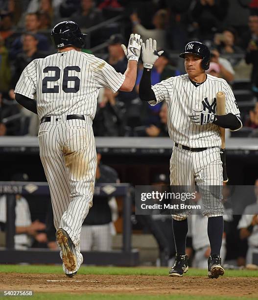 Chris Parmelee and Ronald Torreyes of the New York Yankees celebrate after Parmelee hit a solo home run during the sixth inning of the game against...