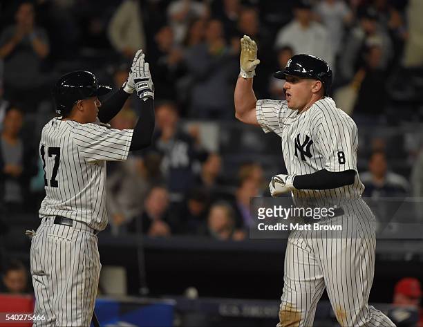 Ronald Torreyes and Chris Parmelee of the New York Yankees celebrate after Parmelee hit a two-run home run during the seventh inning of the game...